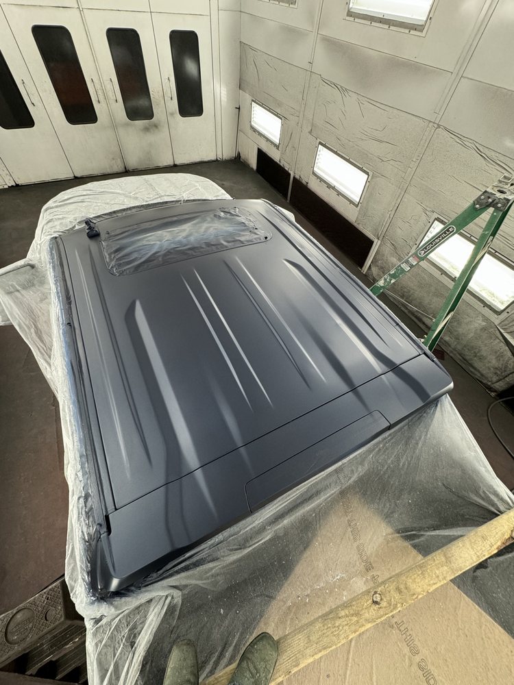 Controlled booth finish work on a masked vehicle roof