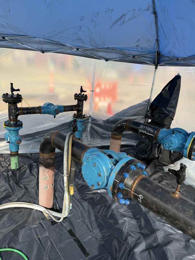Pipe system masked inside a temporary containment area before coating