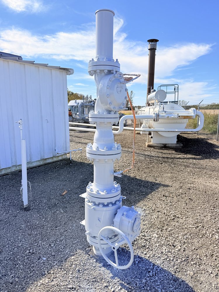 White coated valve assembly and industrial equipment in an outdoor facility